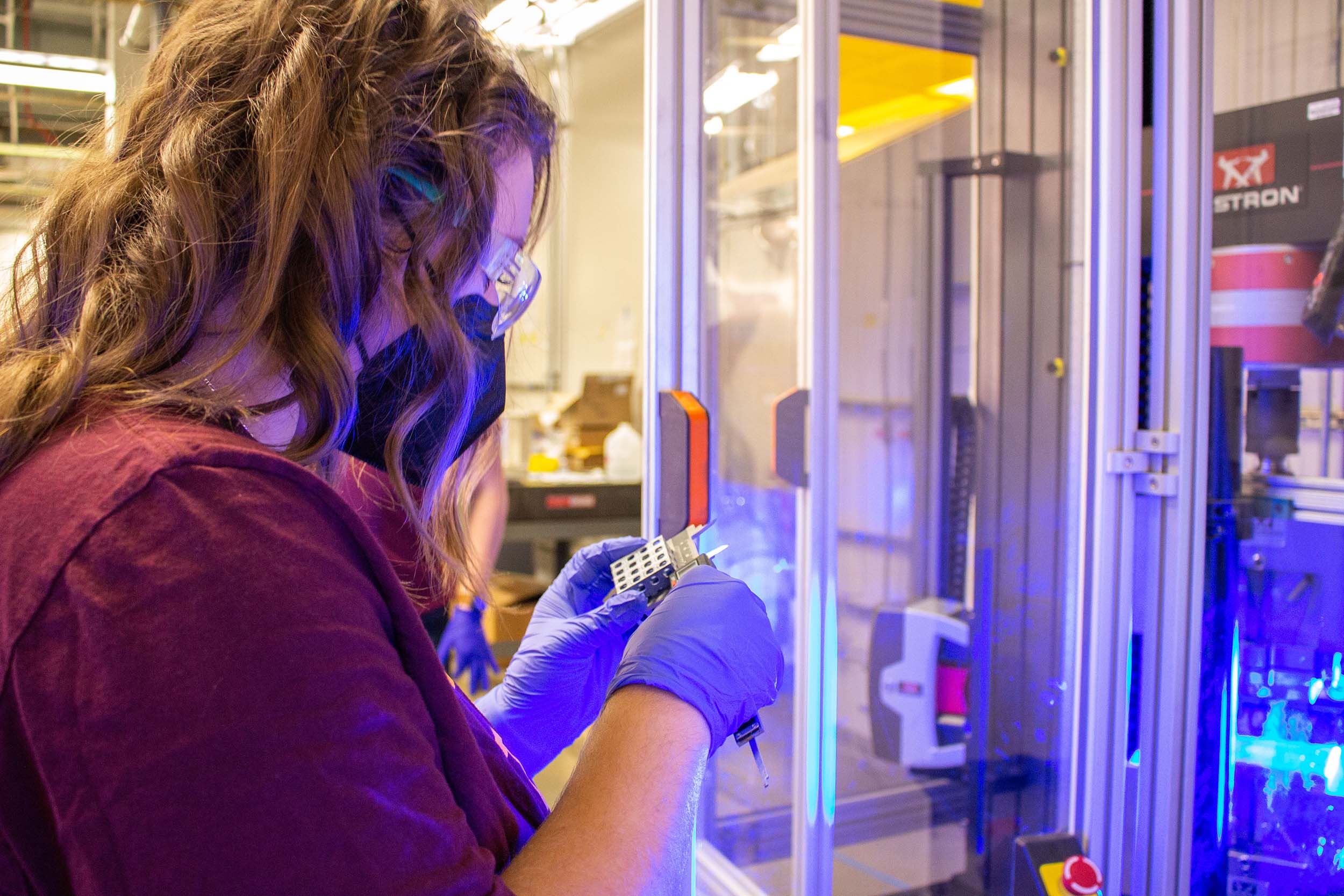 An ASU manufacturing engineering student measures an object produced by additive manufacturing.