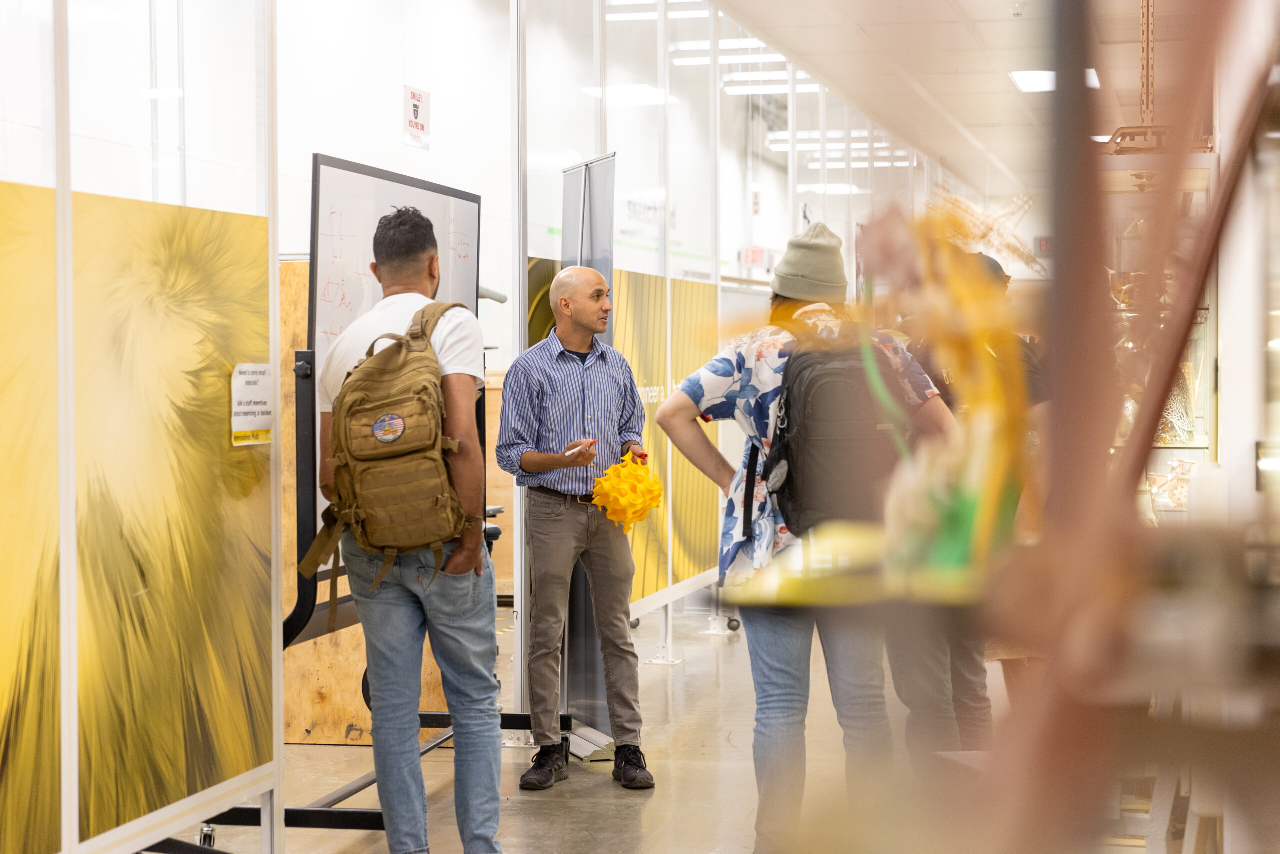 Dhruv Bhate speaks to student in the Technology Center Innovation Hub.