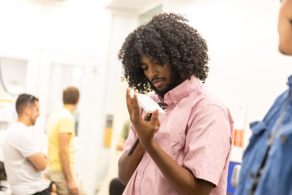 A student observes a 3D printed object in the Innovation Hub.